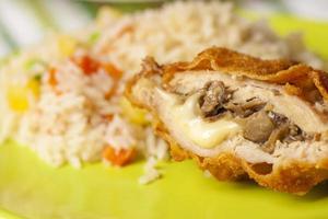 Breaded chicken filled with cheese and mushroom photo