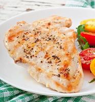 Grilled chicken breasts and vegetables photo