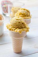 Homemade mango ice cream on vintage light white wooden backgroun photo