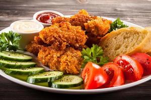 Chicken nuggets and vegetables photo