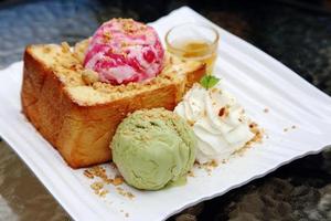 Strawberry ice cream and green tea and bread. photo