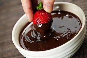 sumergir una fondue de chocolate fresa foto