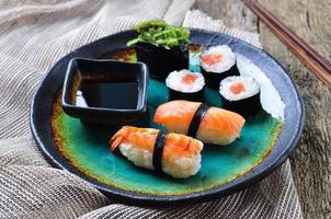 homemade sushi with wild salmon, shrimp, cucumber and seaweed photo