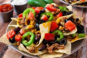 Plate of spicy fully loaded Mexican nachos photo