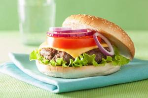 cheeseburger with beef patty cheese lettuce onion tomato photo