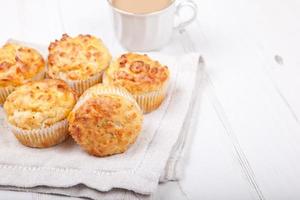 Savory cheese and bacon muffins on the white table photo