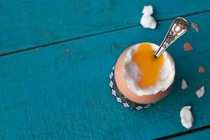 Hard-boiled egg on the blue wooden table photo