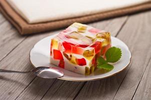 fruit dairy, red and green jelly on a plate. photo