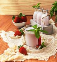 Strawberry milkshake on a rustic wooden table photo