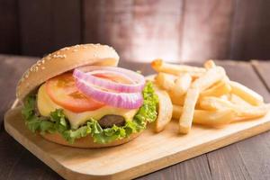 BBQ hamburgers with french fries on wooden background photo