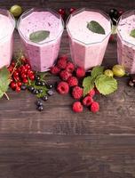 Glasses of various fresh berries smoothies photo