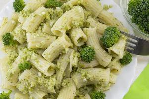 Pasta with broccoli served with cooked broccoli close up