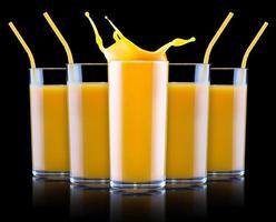 Fresh orange juice in glass with splash photo