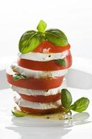 Stack of fresh mozzarella cheese and sliced tomatoes