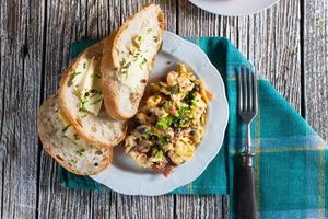 Scrambled eggs with ham and chives. photo