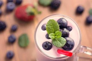 Glass of blueberry smoothie with mint