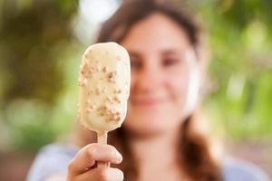 Girl holding a white chocolate ice-cream photo