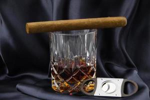 Glass of whiskey and cigar photo
