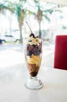 Chocolate sundae in the clear glass cup photo