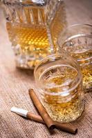 Close up of cigar and whiskey glasses photo