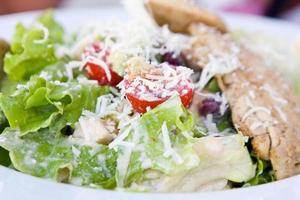 Healthy salad with chicken and vegetables in bowl photo