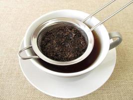 Black tea in tea strainer