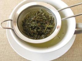 Green tea in tea strainer