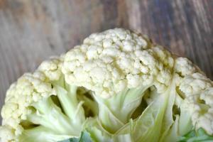 Fresh and raw white cauliflower on wooden table