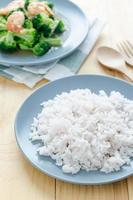 Organic rice on wood table with broccoli