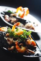 Black spaghetti with seafood photo