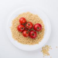 Plate of pasta with tomato from above isolated photo