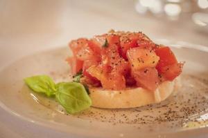 Delicious starter bruschetta with baguette tomato and basil