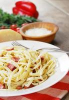 Pasta carbonara on the wooden table photo