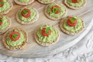 Green avocado and tomato crackers photo