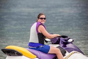 Yound Woman riding a jet ski photo