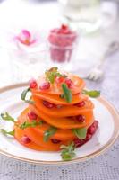 salad of arugula, persimmon, pomegranate photo