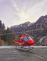 Red helicopter in heliport at swiss alps 2 photo