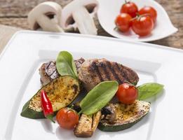 grill meat, with fresh vegetables on plate decoarted