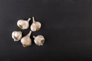 garlic cloves on dark chalkboard