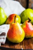 Pears on wooden background photo