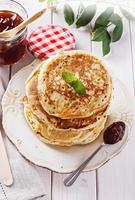 Healthy oat pancakes over white wooden background photo
