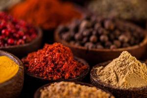 Wooden table of colorful spices photo