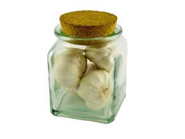 Garlic bulbs in glass jar photo
