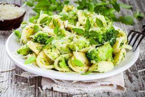 homemade pasta orecchiette with broccoli, Parmesan cheese and basil photo