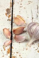 Garlic bulbs and cloves on wooden table photo