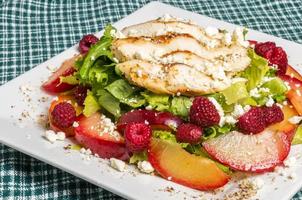 Chicken salad with plums and raspberries photo