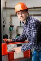 young engineer adjusting system work on control panel photo