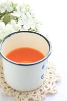 tin cup and carrot juice photo