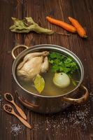 chicken broth with vegetables and spices in a saucepan