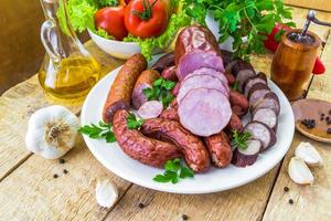 plate various kinds sausages surrounded greens photo